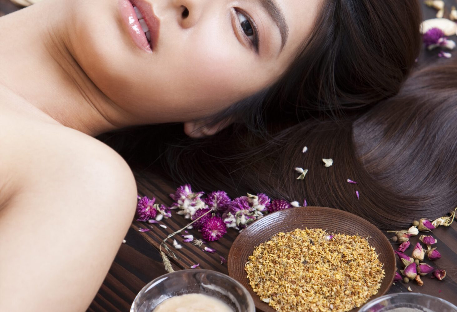 Beautiful young Chinese woman with herbal beauty treatment